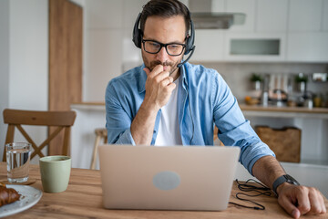 Fototapeta premium One man caucasian male freelancer work from home on laptop computer