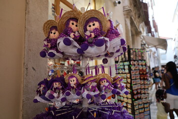 Purple souvenir dolls for sale in the old town in Zadar in Croatia