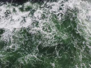 The texture of the waves of turquoise color of fast-flowing water in the river.