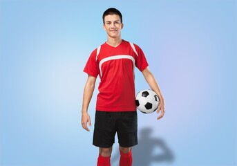 Portrait of young happy man football player with ball