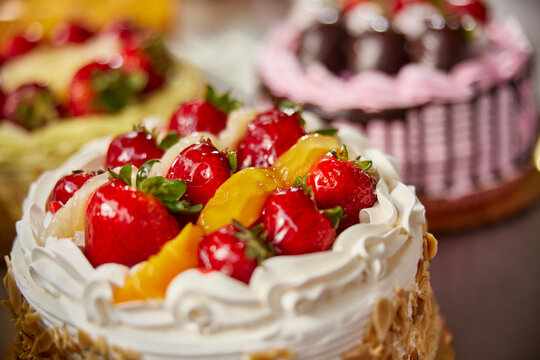 Detail shot of finished cakes in display case of grocery store bakery 