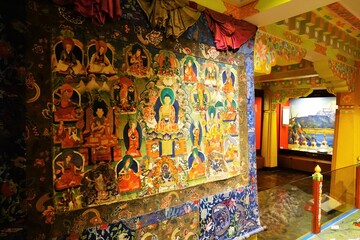 Explore Tibetan spirituality with a captivating Thangka adorned with vibrant Buddhist deities,...