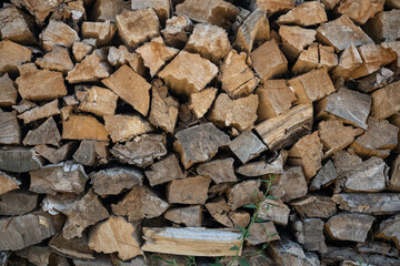 Side view of chopped firewood stacked.