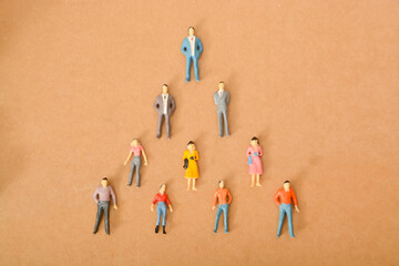 The concept of people forming a team in a pyramid shape reflects the idea of a hierarchical structure within a group or organization