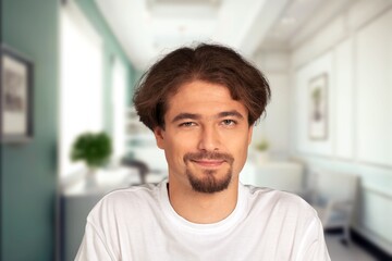 Young handsome man posing in room at home.