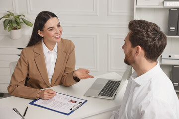 Human resources manager conducting job interview with applicant in office