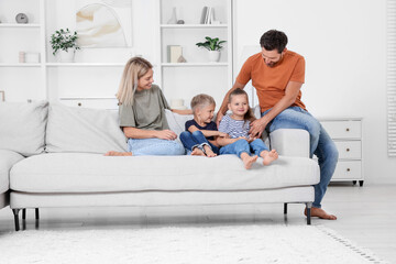 Happy family spending time together on sofa at home
