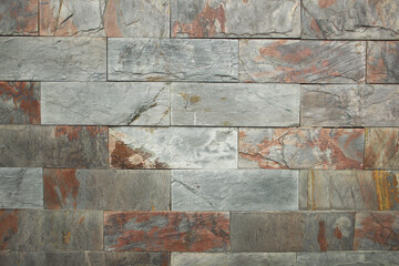 Background of stone-like slabs with veins of blue, light blue and bronze colors.