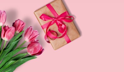 Mother's Day concept. giftbox with ribbon and bouquet of flowers