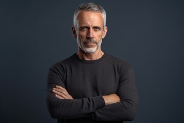 Fototapeta premium A man in a black sweater with his arms crossed