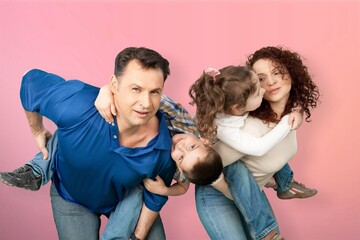 Young parents with child posing together on background