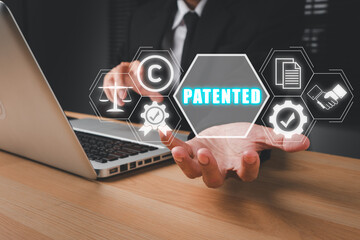Patent concept, Person hand holding patented icon on virtual screen, Patent Copyright Law Business technology concept.