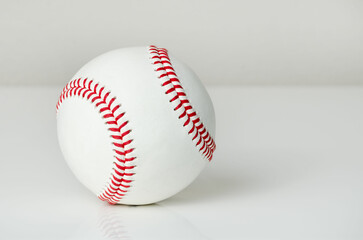 Closeup of a baseball ball with red stitches