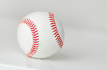 Closeup of a baseball ball with red stitches
