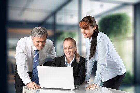 businesswoman working in modern office with laptop, AI generated image