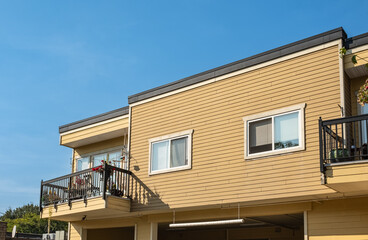 Fototapeta na wymiar Apartments building against blue sky. Residential townhouses. Modern apartment buildings in BC Canada