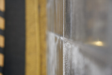 Selective focus of a stone house close-up with a blurry view. Texture of a concrete surface with space to copy. High quality photo