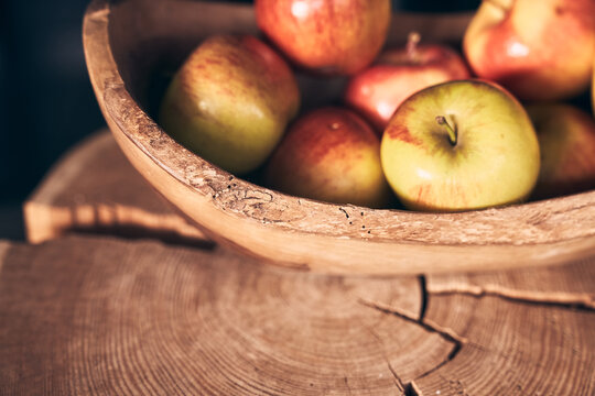 Part of a wooden plate with apples. Fresh red apples on a plate, healthy food on a wooden surface top view. High quality photo