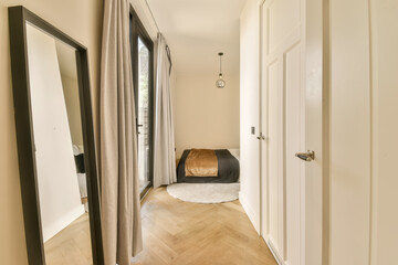 a hallway with wooden floors and large mirrors on the wall, as well as it is in this modern home