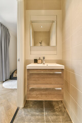 a bathroom with a sink, mirror and toilet paper on the wall next to it is an open shower stall