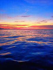 Sea sunset soft blurred background, ocean sunrise, tropical island beach dawn, dark blue water...