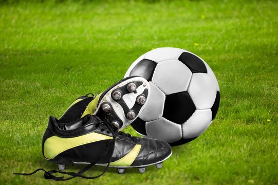 Sporty Boot and soccer or Football Ball at stadium