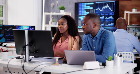 African Financial Data Analysts Using Dashboard On Screens