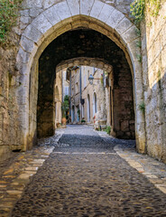 Arched passage way in the traditional medieval stone city walls of the Old Town, Vieille Ville in Saint Paul de Vence, French Riviera, South of France