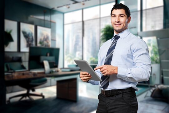 Handsome young businessman works on digital tablet in the office, AI generated image