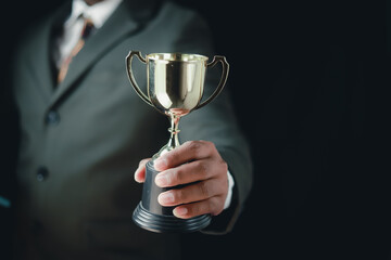 Businessman, success, company president Holding an outstanding trophy for corporate development of an investment company	