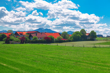 Fototapeta na wymiar Rural landscape in Bavaria, Germany. Green meadow and village