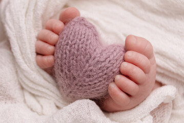 baby feet and a crocheted heart