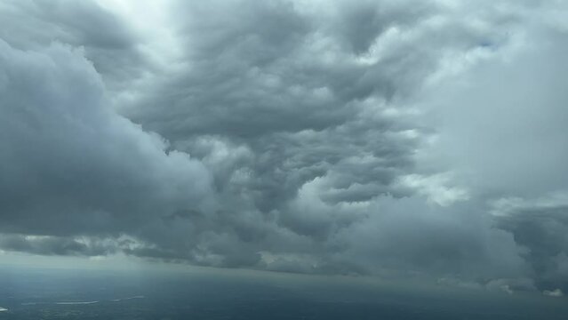 Awesome view from a jet cain while flying near the botton of a huge storm cloud in a left turn to avoid. 5000m high. A pilot&rsquo;s POV