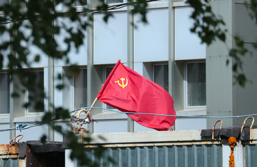 Red Soviet flag with hammer and sickle.