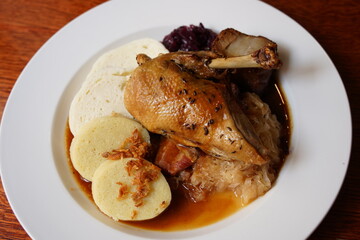 Baked duck leg with Czech dumplings and sauce. Traditional czech cuisine
