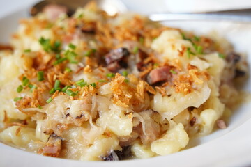 A traditional Czech dish, potato gnocchi , bacon, bacon fat and fried onions, cabbage Sauerkraut