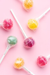 Sweet lollipops on pink background