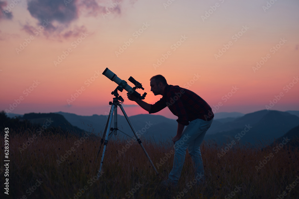 Canvas Prints astronomer looking at the skies with a telescope.