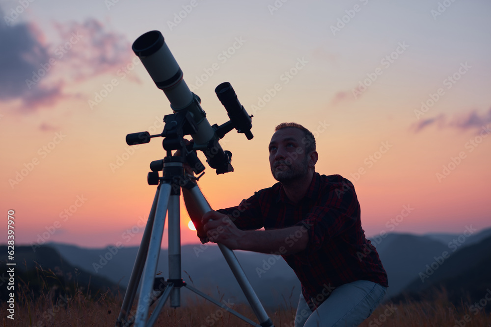 Canvas Prints astronomer looking at the skies with a telescope.