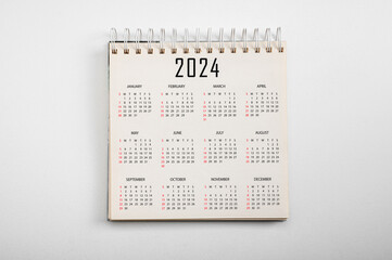 Calendar Year 2024 schedule on paper background. Flat lay with calendar. 12 months desk calendar...