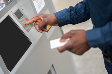 Close up picture of a man retrieving money from ATM