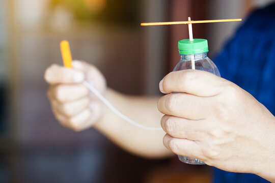 Close up DIY toy helicopter made of waste and plastic bottles and ice cream sticks. Concept, Recycle crafts. Toy for kids, Teaching aid, fun activity for active learning.  