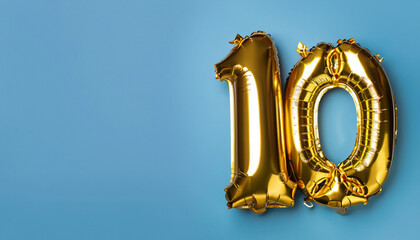 Banner with number 10 golden balloon with copy space. Ten years anniversary celebration concept on...