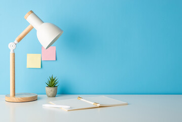Get ready to learn! Side view photo of a desk adorned with school supplies, open notebook,...