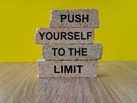 Push The Limit Symbol. Concept Words Push Yourself To The Limit On Brick Blocks. Beautiful Wooden Table Yellow Background. Business Push The Limit Concept. Copy Space.