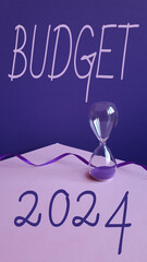 2024 text with hourglass on pink table. Resolution, time, plan, goal, motivation, reboot, countdown...