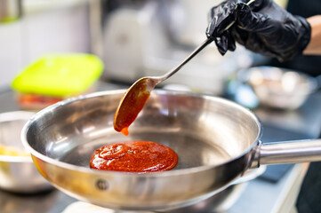 Tomato Sauce with Spoon in Metal Pan