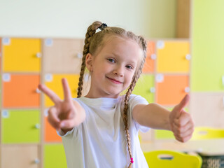 Portrait of a cute little girl with braids in a schoolclass