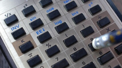 Accountant Using Retro Calculator Pencil Close-up