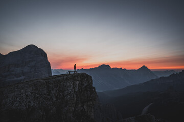 Silhouette of a person during a morning sunrise in the mountains of Italy